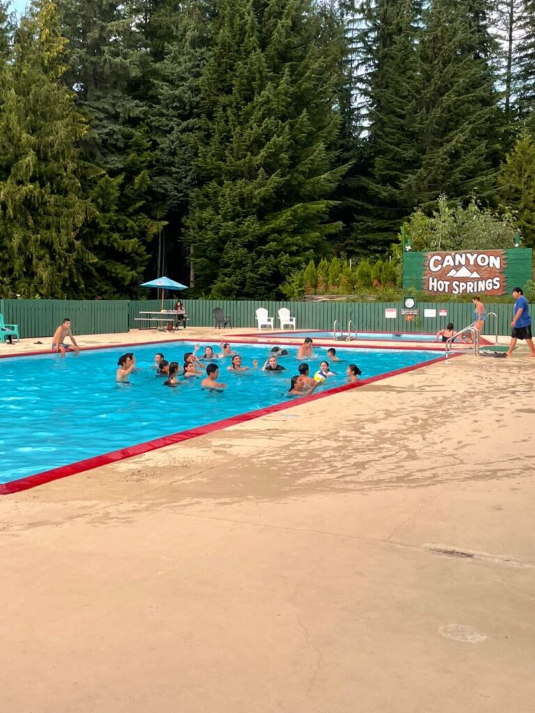 Guests swimming at the Canyon Hot Springs pool near Revelstoke